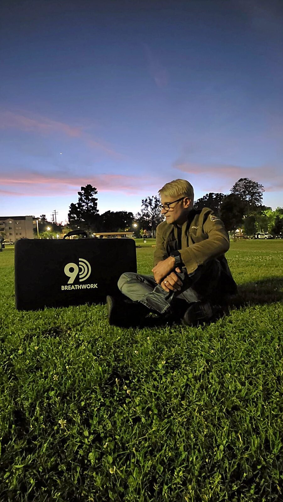 Edwin Rivera-Cortez, Certified 9D Breathwork Facilitator, setting up a session at twilight